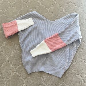 Blue, pink, and white oversized sweater with cross back detail!